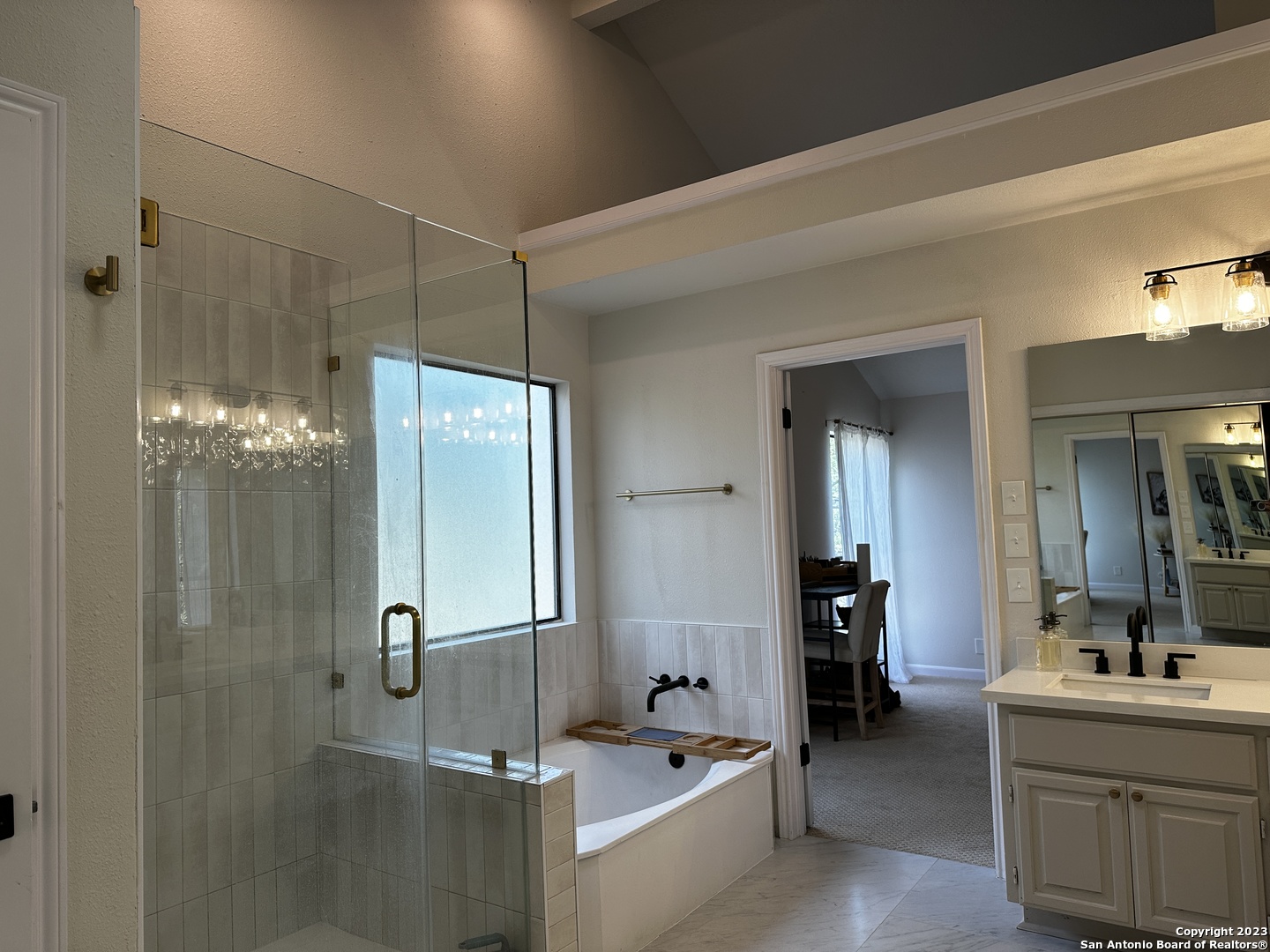 1722 Encino Spring San Antonio, TX 78259 - Photo 44 of 55 a bathroom with a double vanity sink a mirror and shower