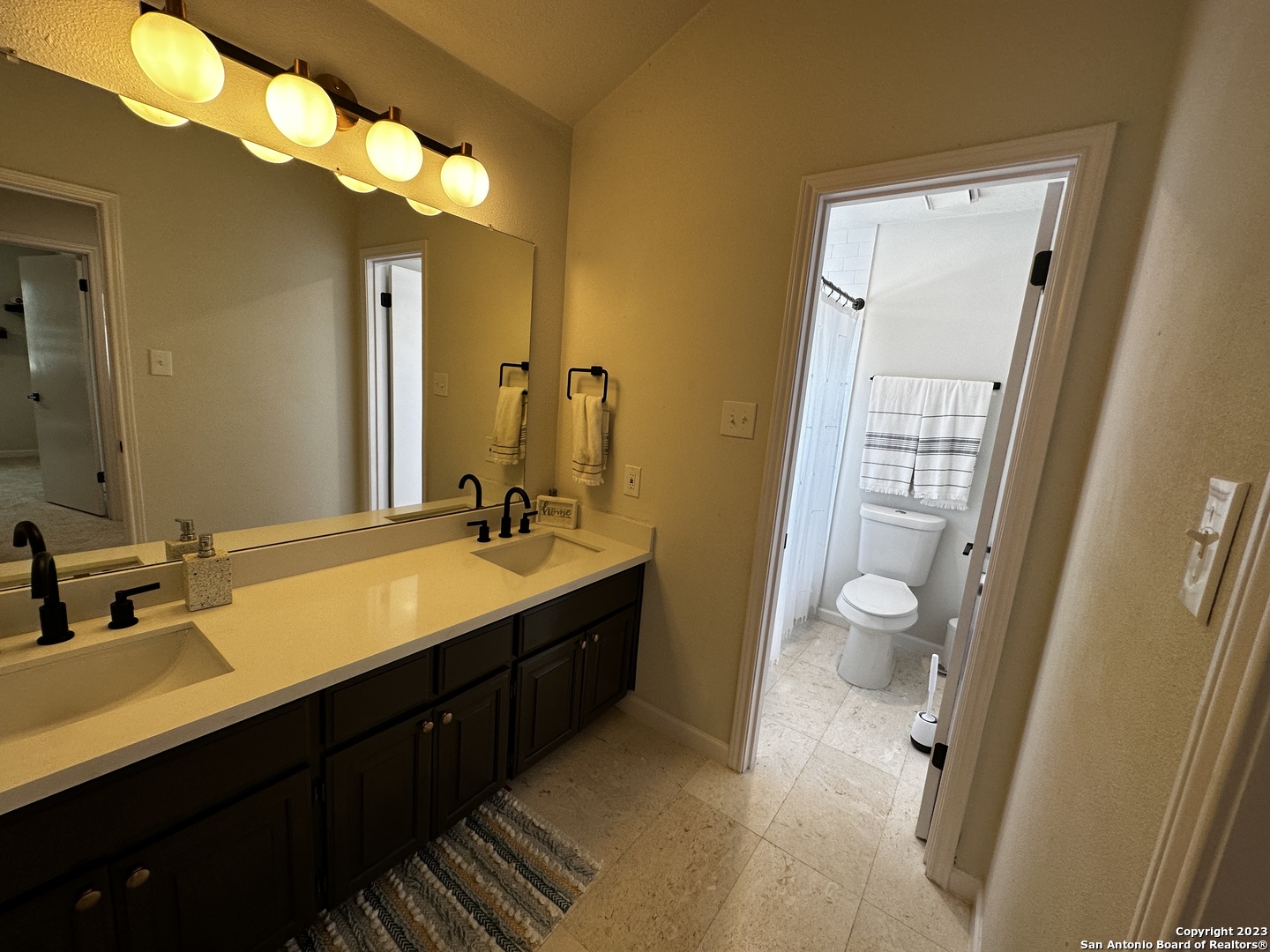 1722 Encino Spring San Antonio, TX 78259 - Photo 52 of 55 a bathroom with a double vanity sink and a mirror