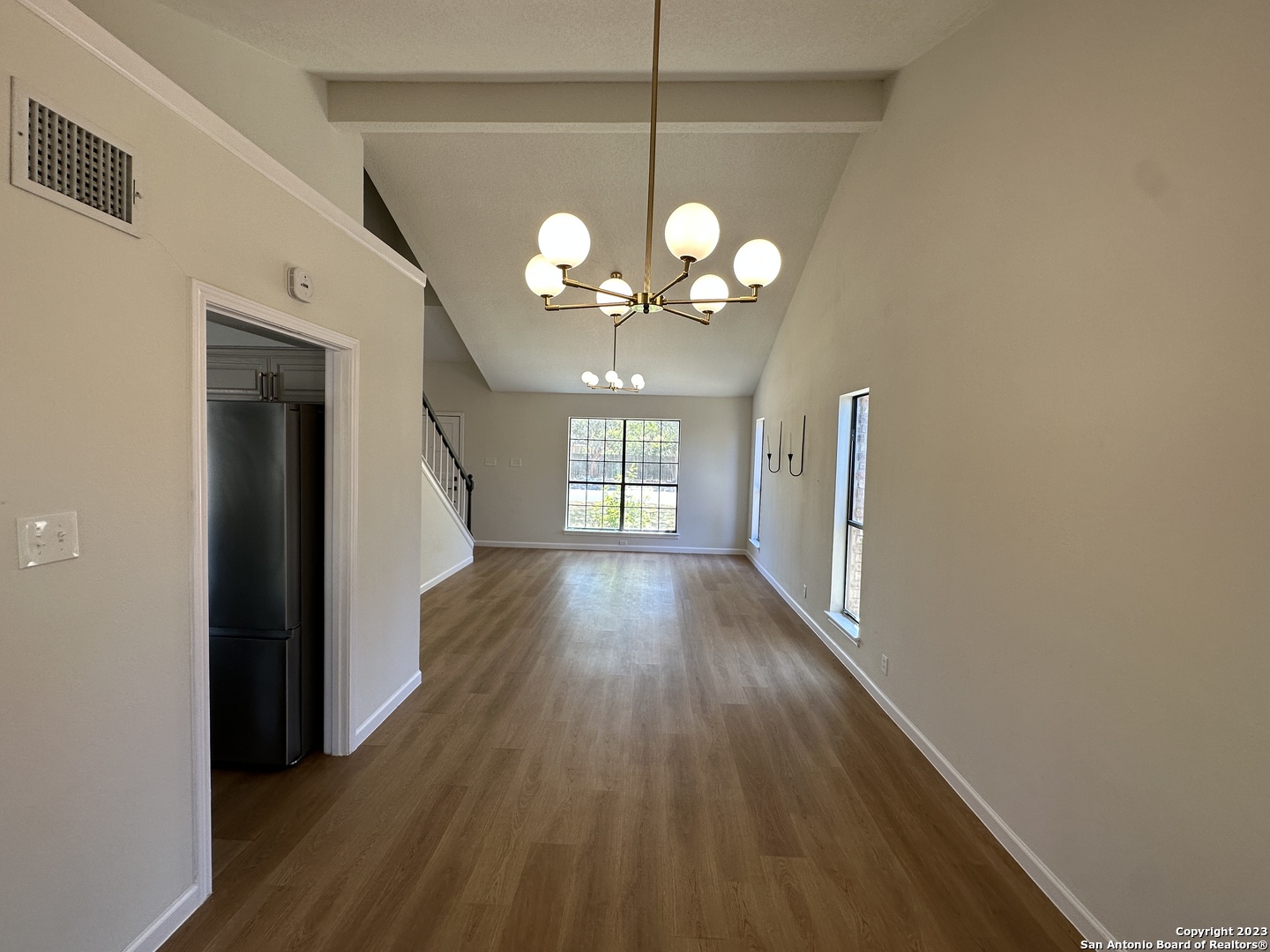 1722 Encino Spring San Antonio, TX 78259 - Photo 6 of 55 a view of a hallway with wooden floor and chandelier