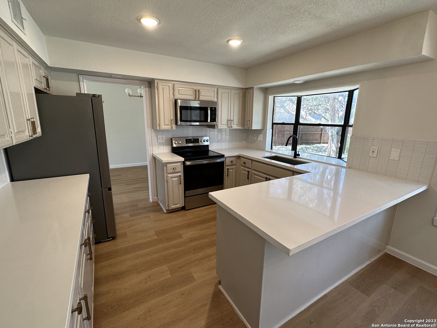 1722 Encino Spring San Antonio, TX 78259 - Photo 7 of 55 a kitchen with stainless steel appliances granite countertop a refrigerator a stove top oven a sink and dishwasher