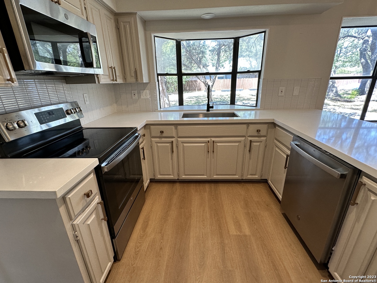 1722 Encino Spring San Antonio, TX 78259 - Photo 8 of 55 a kitchen with a sink a stove and cabinets