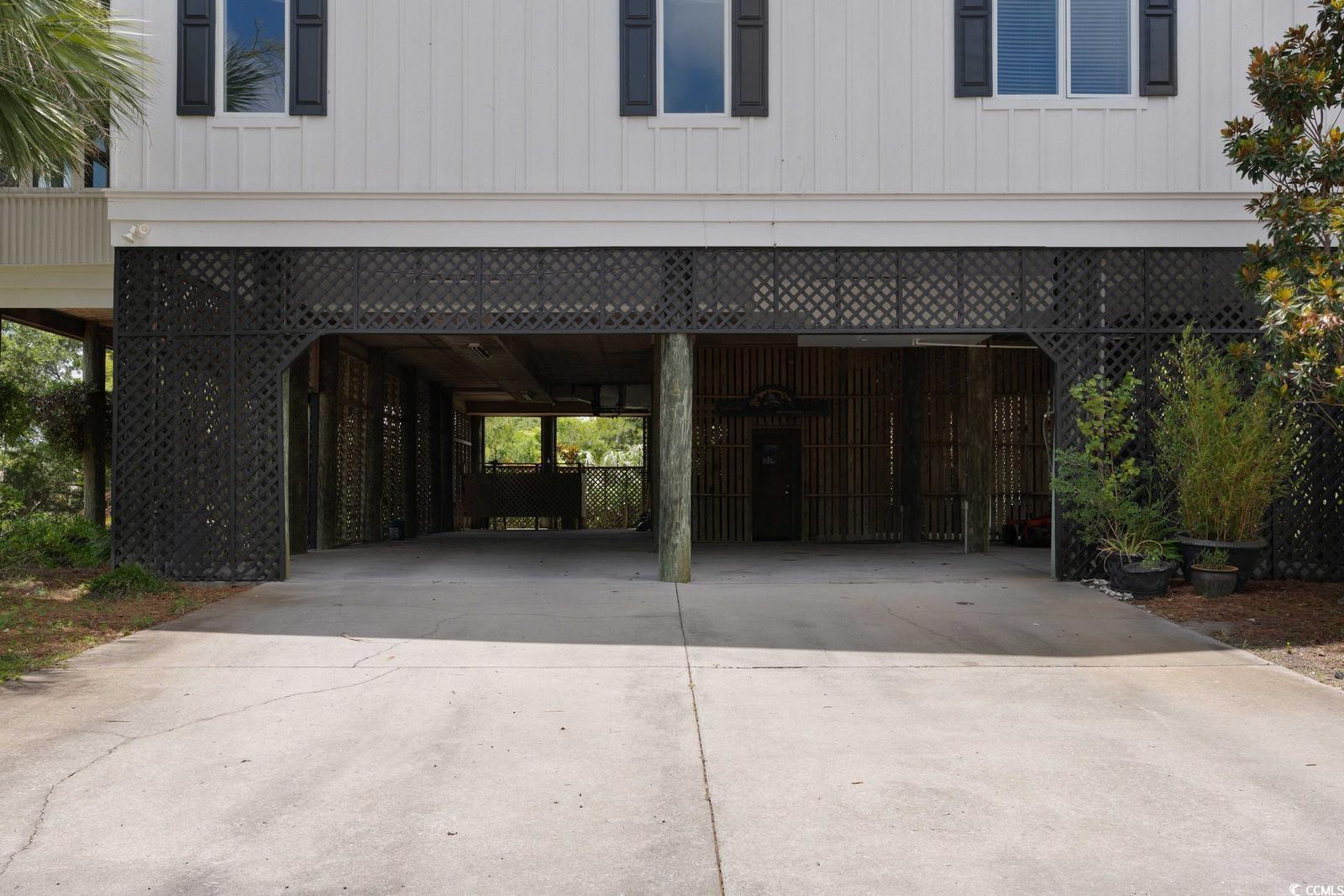 315 Lofton Court McClellanville, SC 29458 - Photo 18 of 40 Garage with a carport and driveway