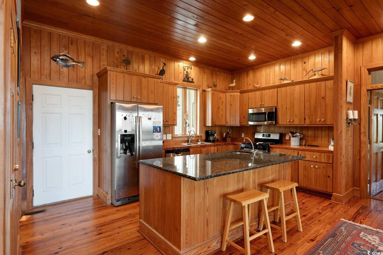 315 Lofton Court McClellanville, SC 29458 - Photo 20 of 40 Kitchen with stainless steel appliances, wooden ceiling, a center island with sink, light wood-style flooring, and recessed lighting