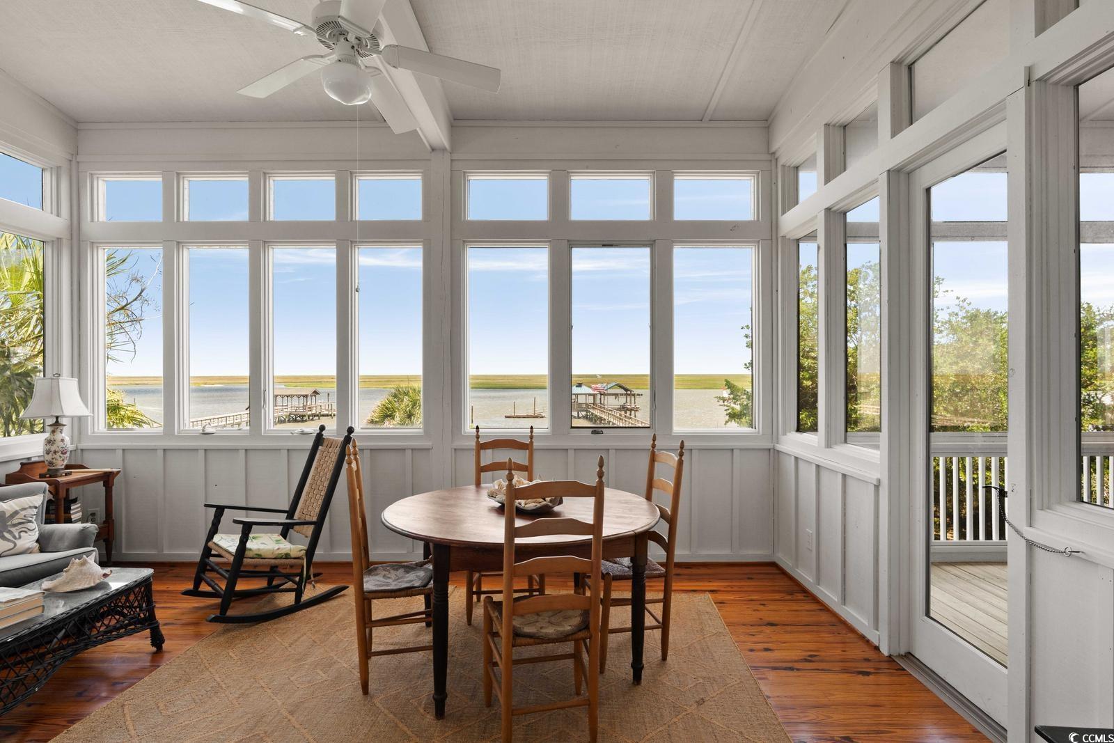 315 Lofton Court McClellanville, SC 29458 - Photo 28 of 40 Sunroom / solarium with hardwood / wood-style floors and a water view