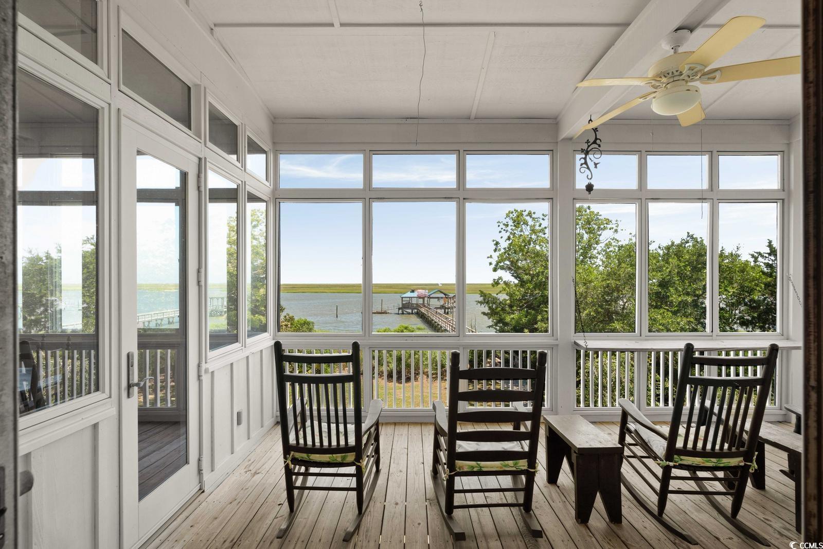 315 Lofton Court McClellanville, SC 29458 - Photo 29 of 40 Sunroom featuring a water view, wood-type flooring, and healthy amount of natural light