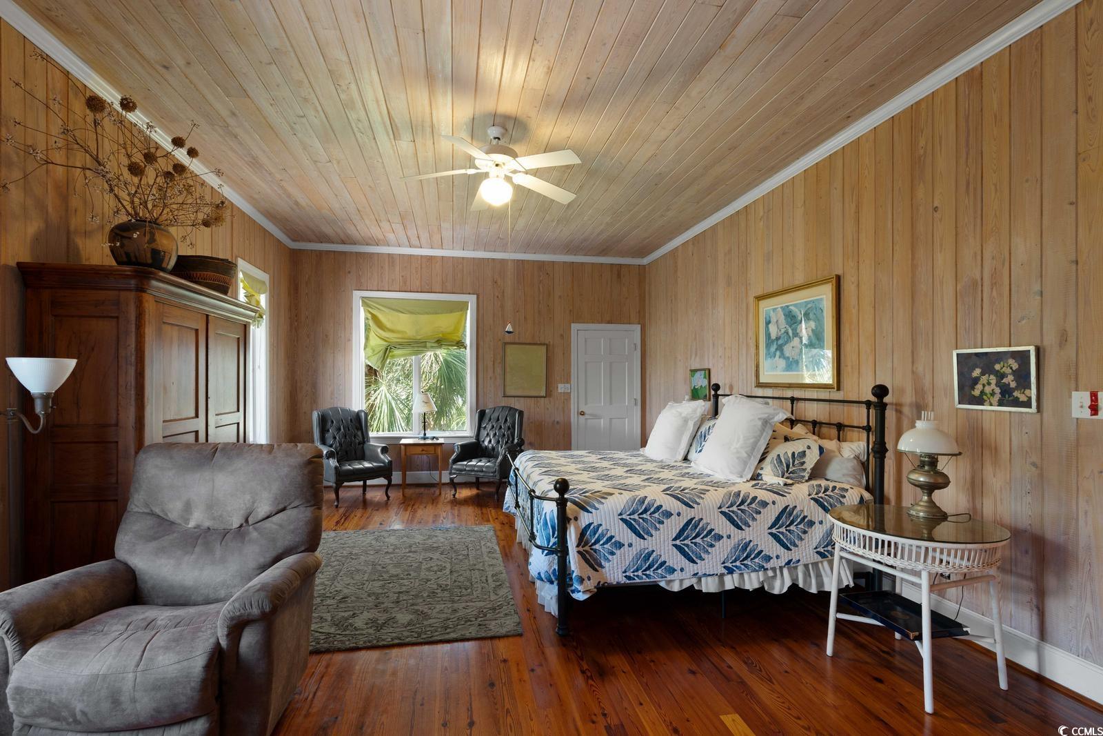 315 Lofton Court McClellanville, SC 29458 - Photo 32 of 40 Bedroom featuring wooden walls, wood ceiling, ornamental molding, and hardwood / wood-style flooring