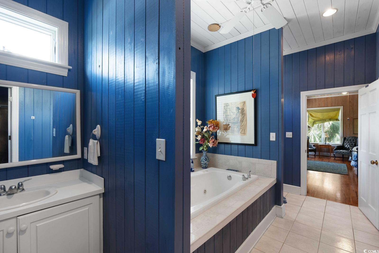 315 Lofton Court McClellanville, SC 29458 - Photo 33 of 40 Bathroom with tile patterned flooring, a tub with jets, vanity, wooden ceiling, and wooden walls