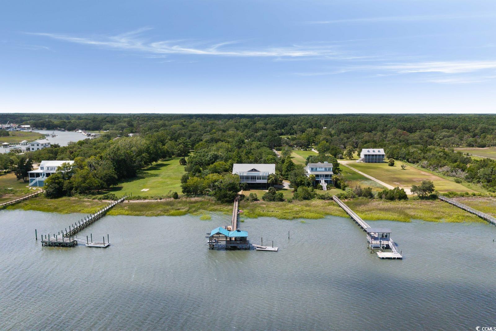315 Lofton Court McClellanville, SC 29458 - Photo 6 of 40 Drone / aerial view of a large body of water and a forest