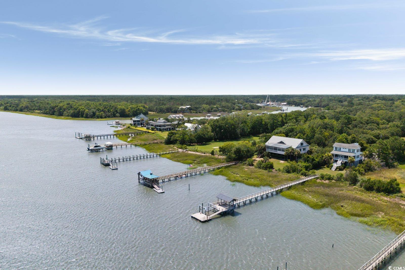 315 Lofton Court McClellanville, SC 29458 - Photo 7 of 40 Drone / aerial view of a large body of water and a forest