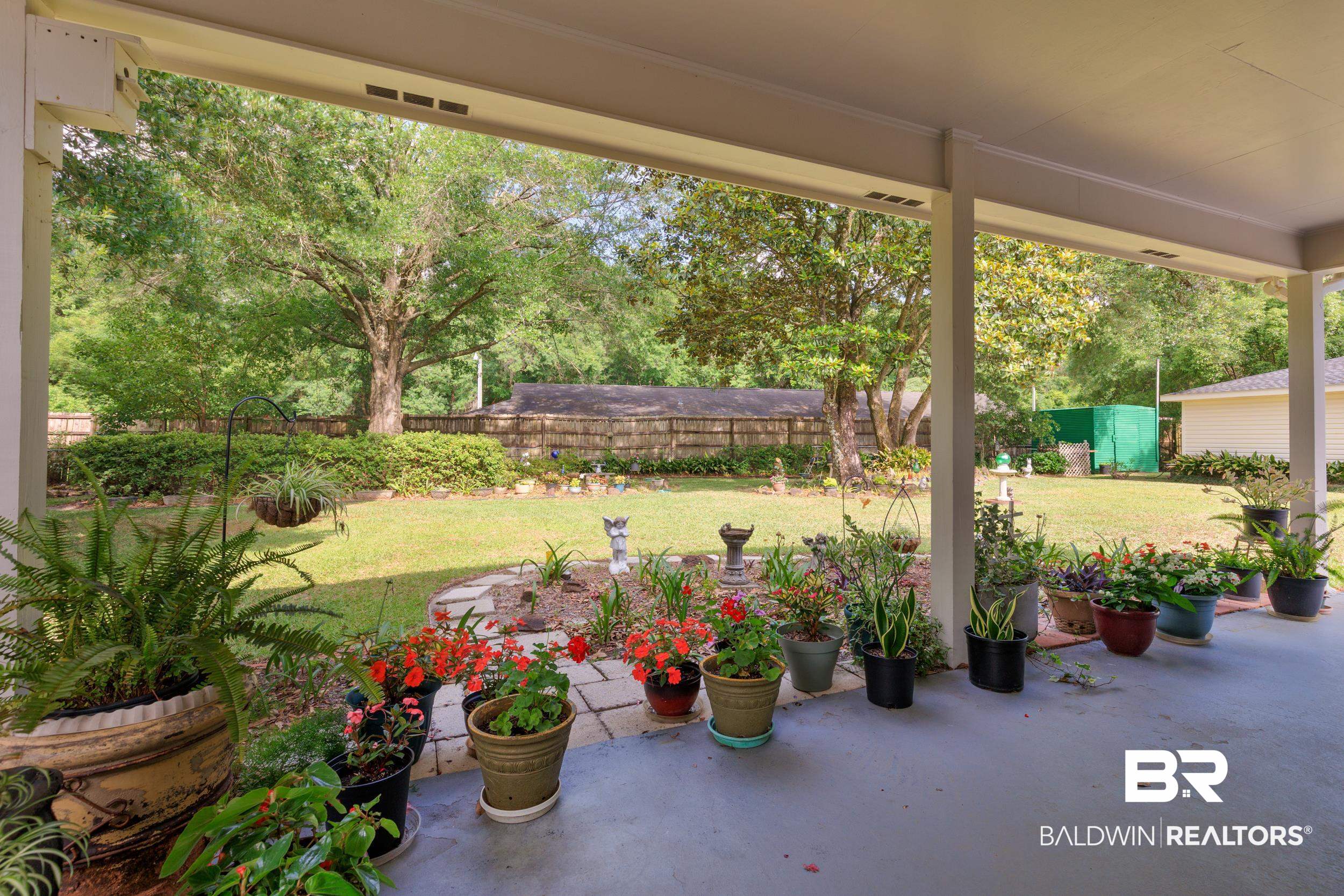 1367 Spring Valley Court Mobile, AL 36693 - Photo 25 of 29 Expansive covered patio with a concrete floor and white support columns