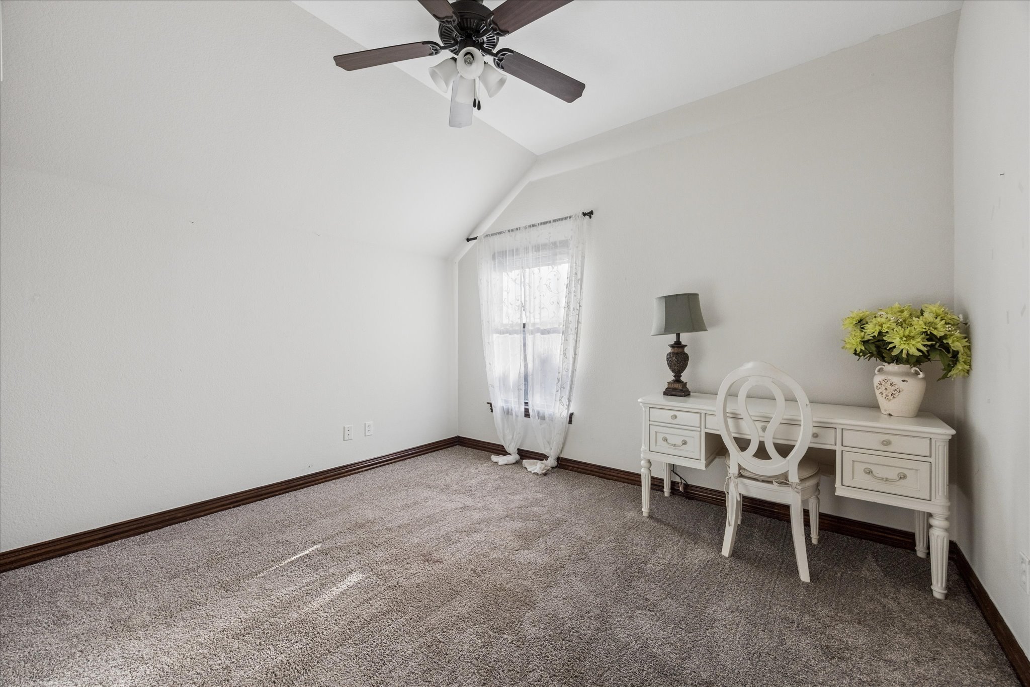 11805 Ranchview Court Austin, TX 78732 - Photo 26 of 36 Carpeted room with a vaulted ceiling, ceiling fan, white walls, and dark wood-finish baseboards
