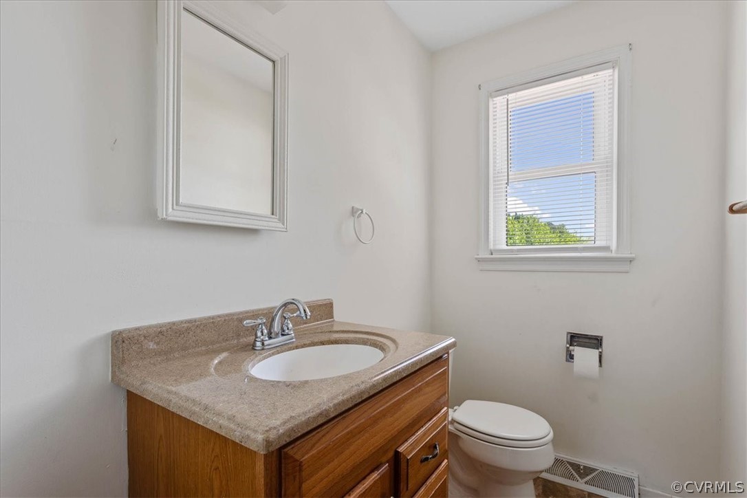 2001 Point Of Rocks Road Chester, VA 23836 - Photo 10 of 25 a bathroom with a granite countertop toilet sink and mirror
