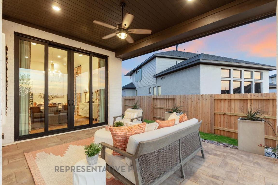 205 Leaning Rock Ridge Austin, TX 78737 - Photo 23 of 40 a living room with furniture a ceiling fan and a large window