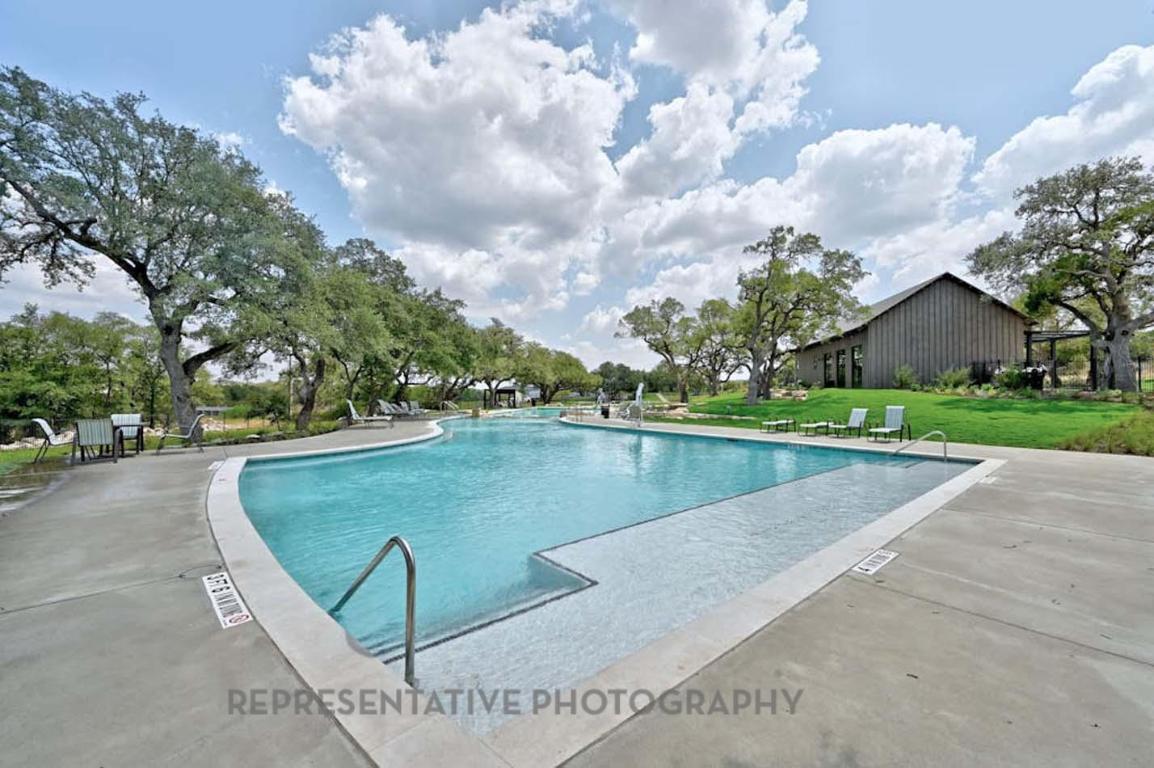 205 Leaning Rock Ridge Austin, TX 78737 - Photo 27 of 40 a view of a swimming pool and trees in the background