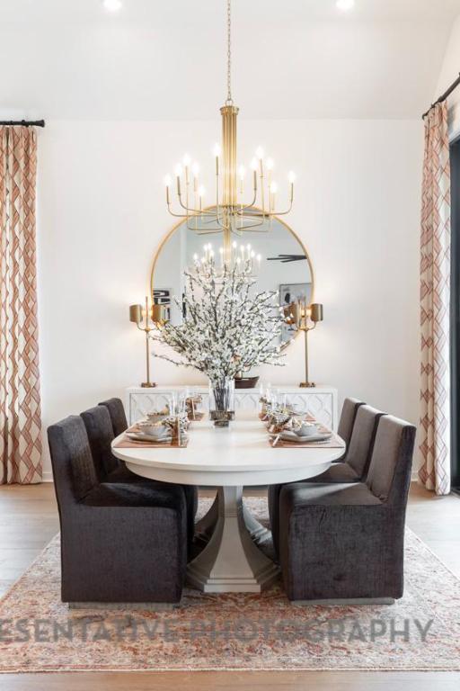 205 Leaning Rock Ridge Austin, TX 78737 - Photo 38 of 40 a dining room with furniture a rug and a chandelier