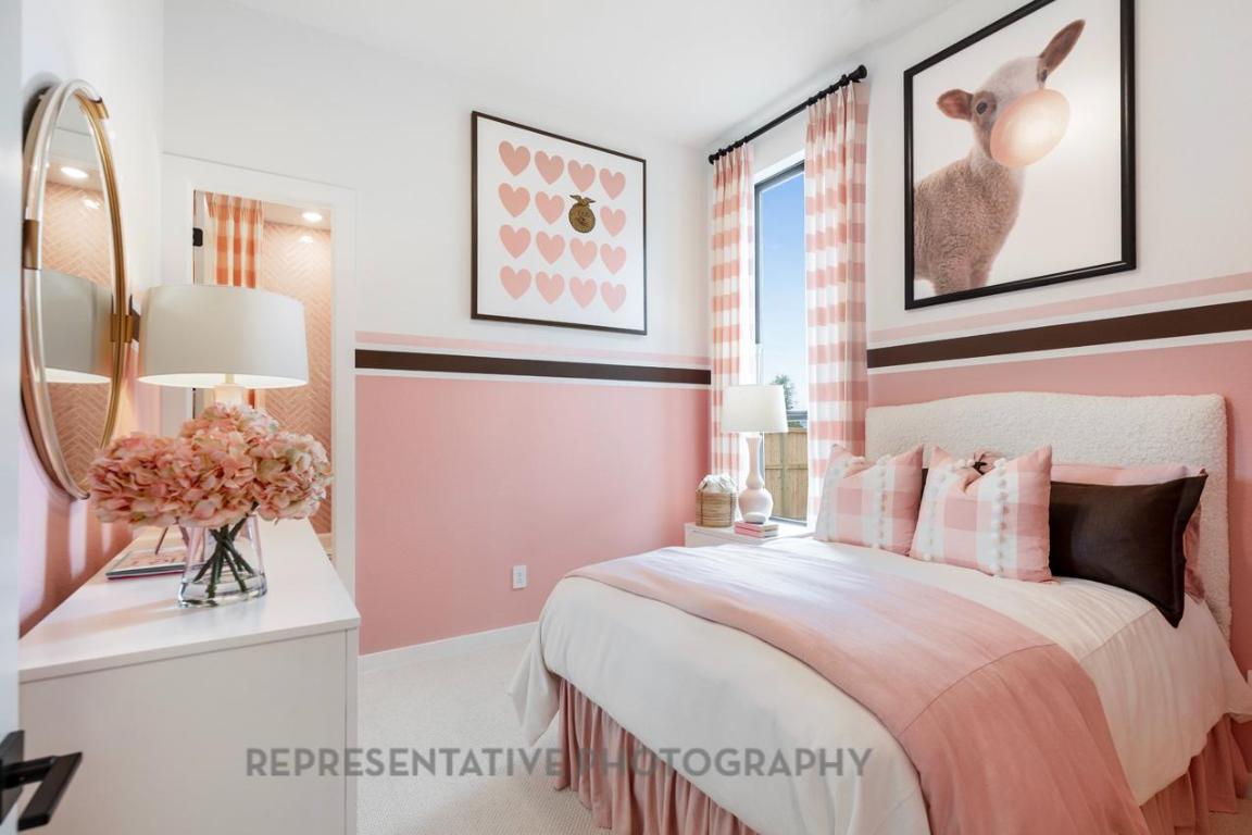 205 Leaning Rock Ridge Austin, TX 78737 - Photo 39 of 40 a bedroom with a bed and a painting on the wall