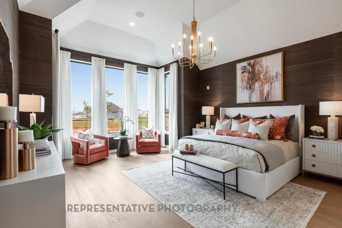 205 Leaning Rock Ridge Austin, TX 78737 - Photo 7 of 40 a spacious bedroom with a bed and a chandelier