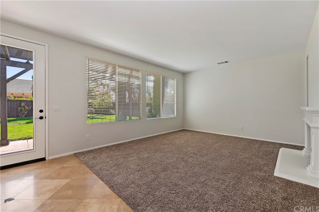 13527 Jasper Loop Eastvale, CA 92880 - Photo 17 of 37 an empty room with windows