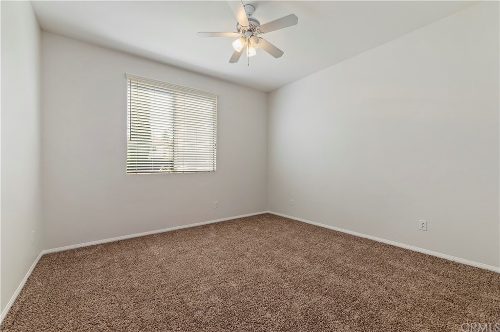 13527 Jasper Loop Eastvale, CA 92880 - Photo 19 of 37 an empty room with a window and a fan