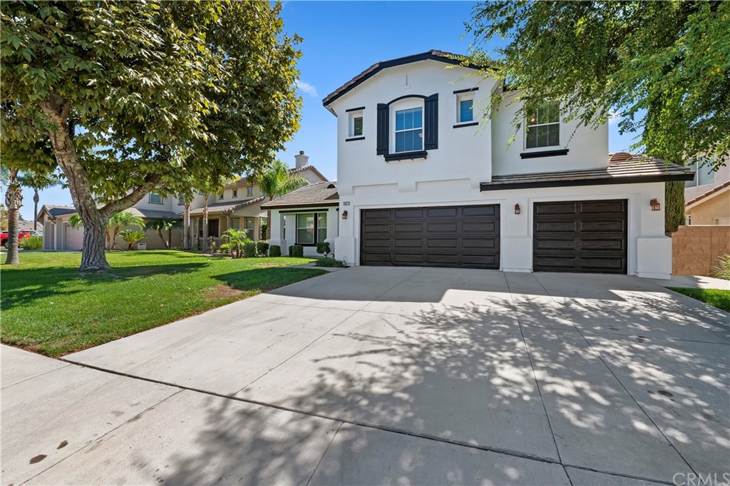 13527 Jasper Loop Eastvale, CA 92880 - Photo 3 of 37 a front view of a house with a yard and garage