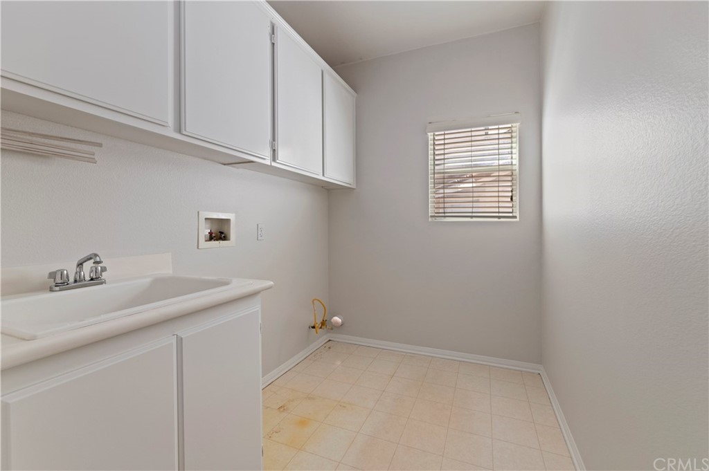 13527 Jasper Loop Eastvale, CA 92880 - Photo 21 of 37 a bathroom with a sink and cabinets