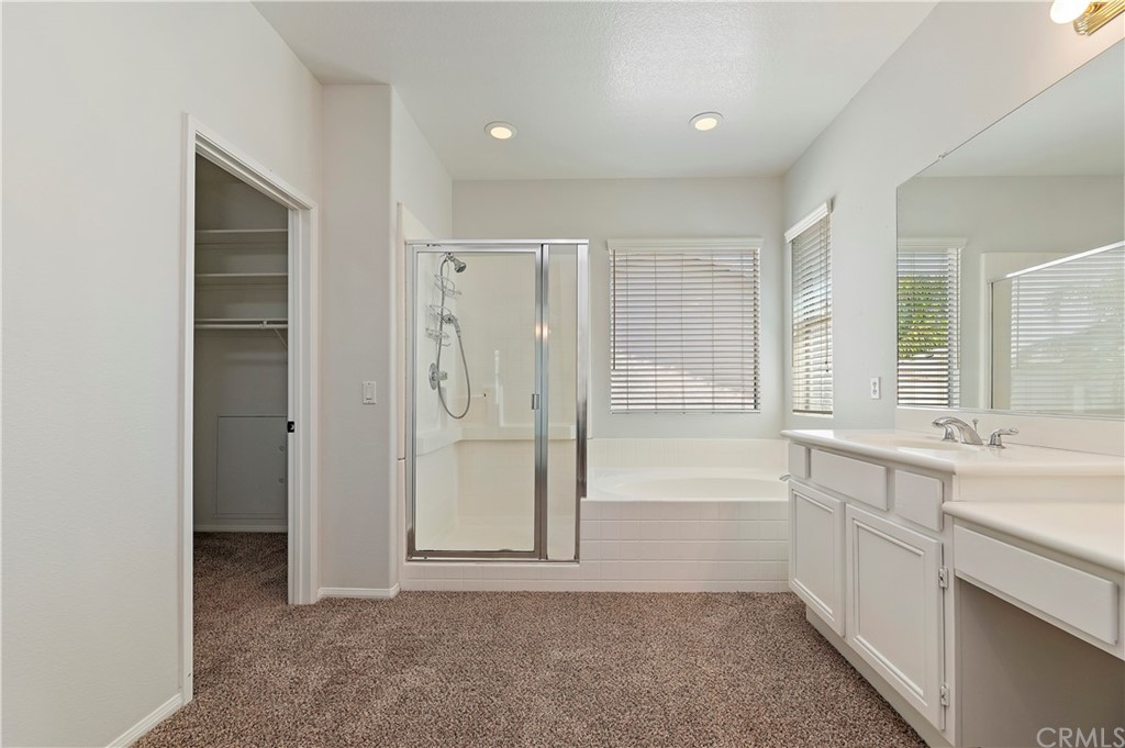 13527 Jasper Loop Eastvale, CA 92880 - Photo 26 of 37 a spacious bathroom with a shower a sink and a bathtub