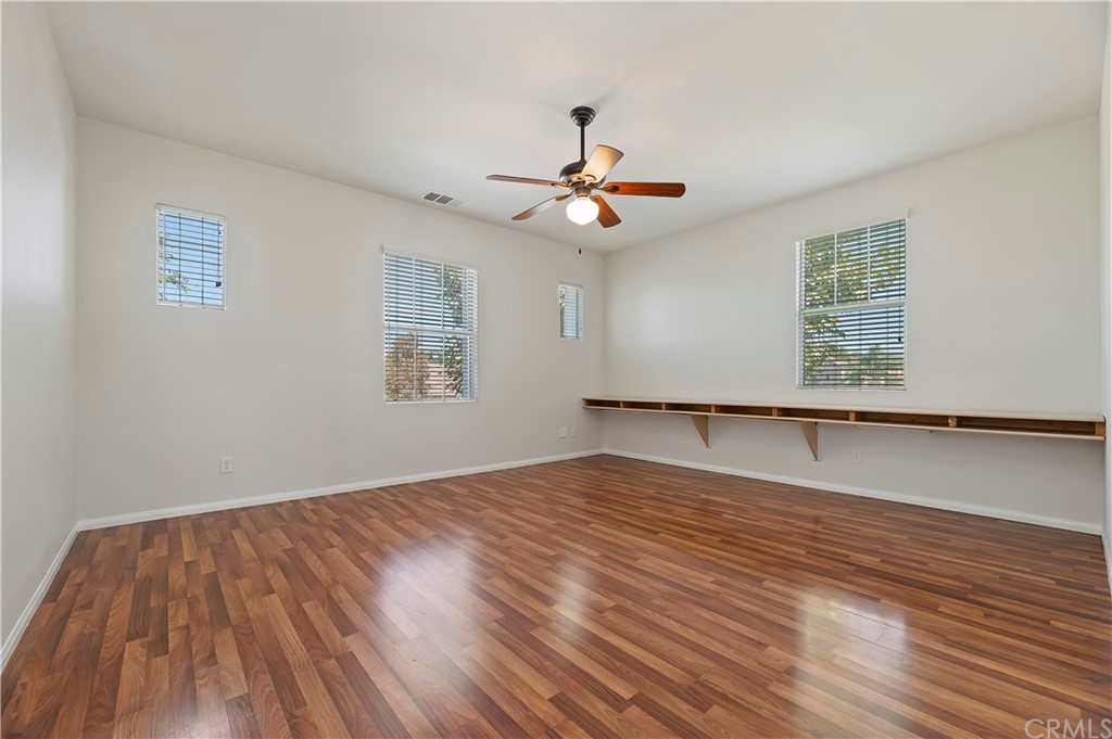 13527 Jasper Loop Eastvale, CA 92880 - Photo 28 of 37 a view of empty room with wooden floor and fan