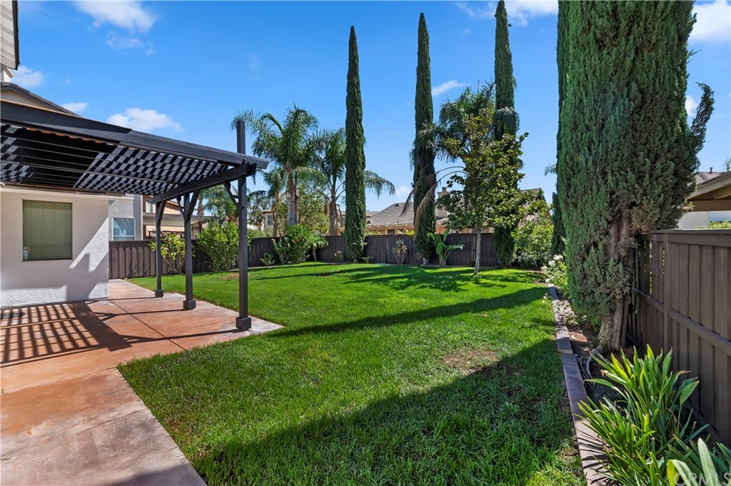 13527 Jasper Loop Eastvale, CA 92880 - Photo 32 of 37 a patio with a yard table and chairs