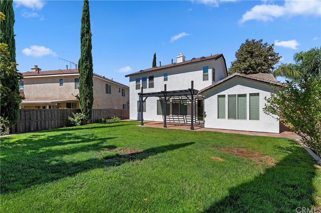 13527 Jasper Loop Eastvale, CA 92880 - Photo 35 of 37 a front view of a house with a garden and yard