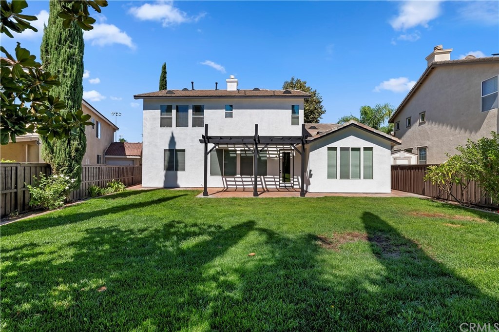 13527 Jasper Loop Eastvale, CA 92880 - Photo 37 of 37 a front view of a house with a garden and yard