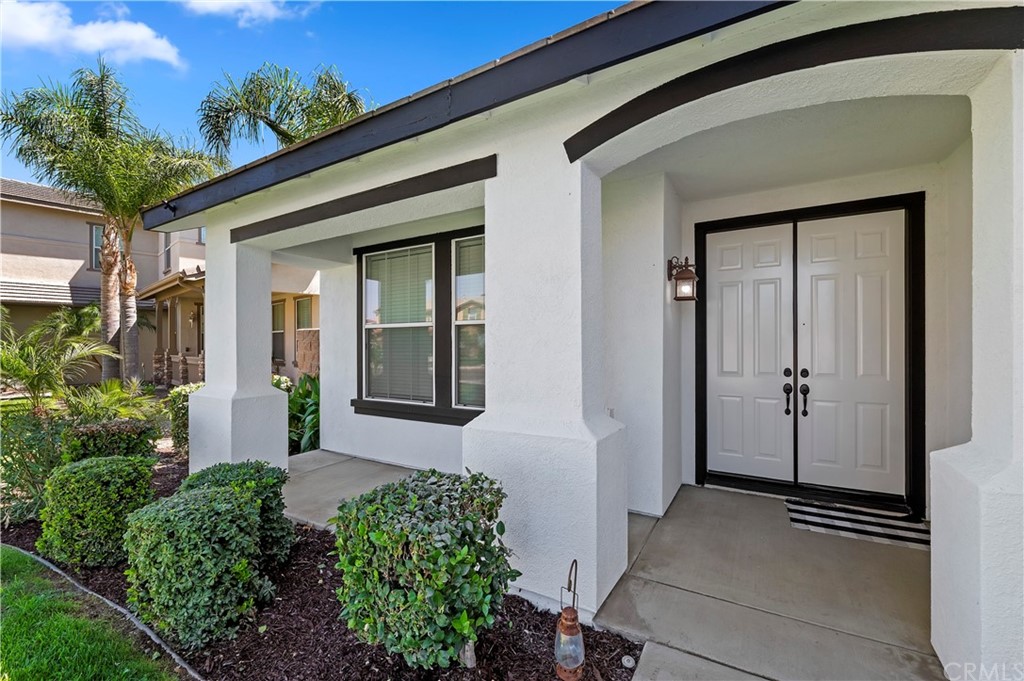 13527 Jasper Loop Eastvale, CA 92880 - Photo 5 of 37 front view of a house with a potted plant