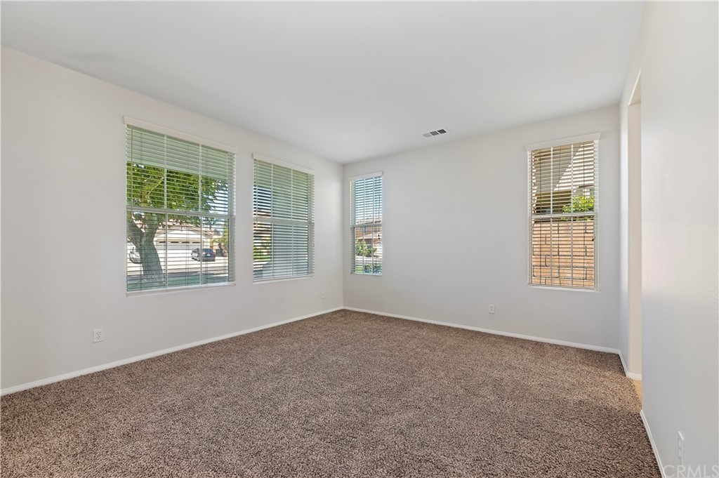 13527 Jasper Loop Eastvale, CA 92880 - Photo 7 of 37 an empty room with windows
