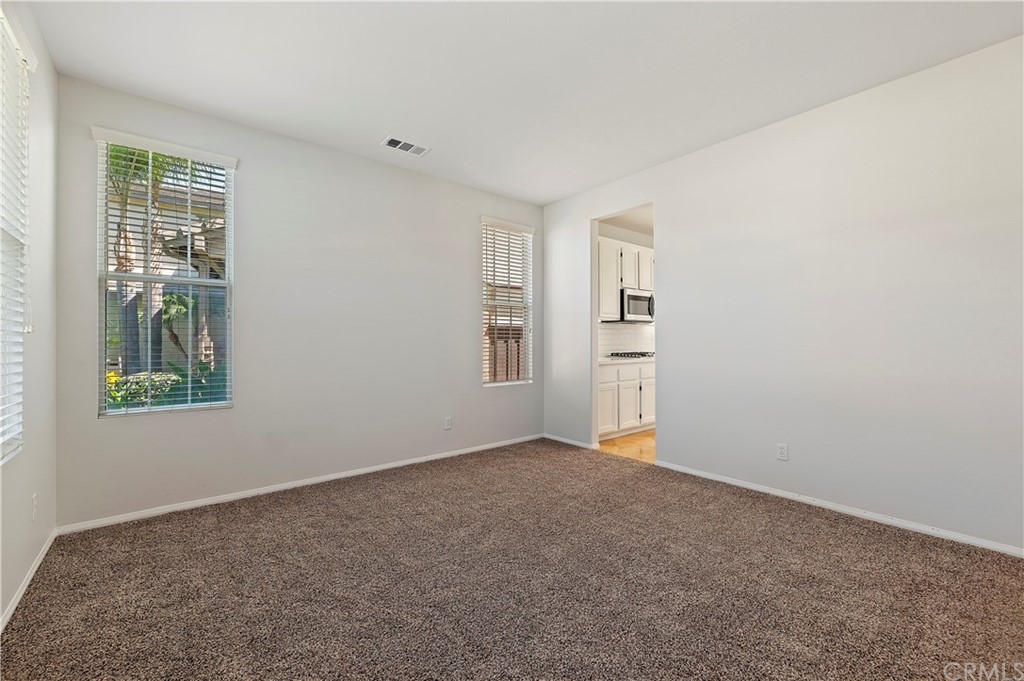 13527 Jasper Loop Eastvale, CA 92880 - Photo 8 of 37 an empty room with windows