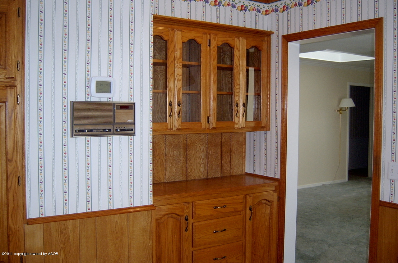 6903 Calumet Road Amarillo, TX 79106 - Photo 11 of 34 a view of a kitchen with wooden floor and cabinet