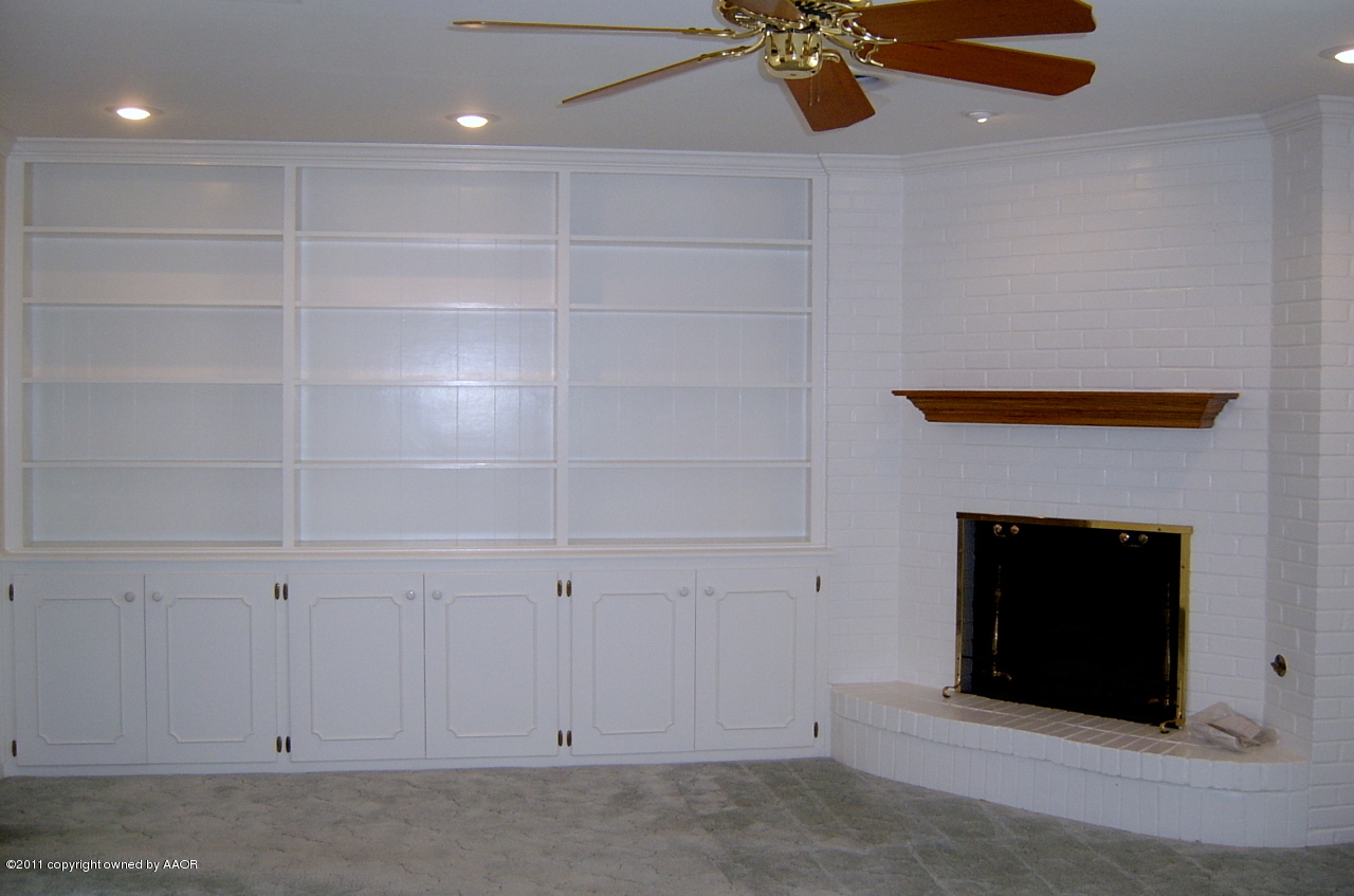 6903 Calumet Road Amarillo, TX 79106 - Photo 14 of 34 a room with a fireplace and cabinets