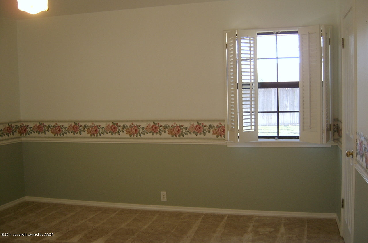 6903 Calumet Road Amarillo, TX 79106 - Photo 23 of 34 wooden floor and window in an empty room