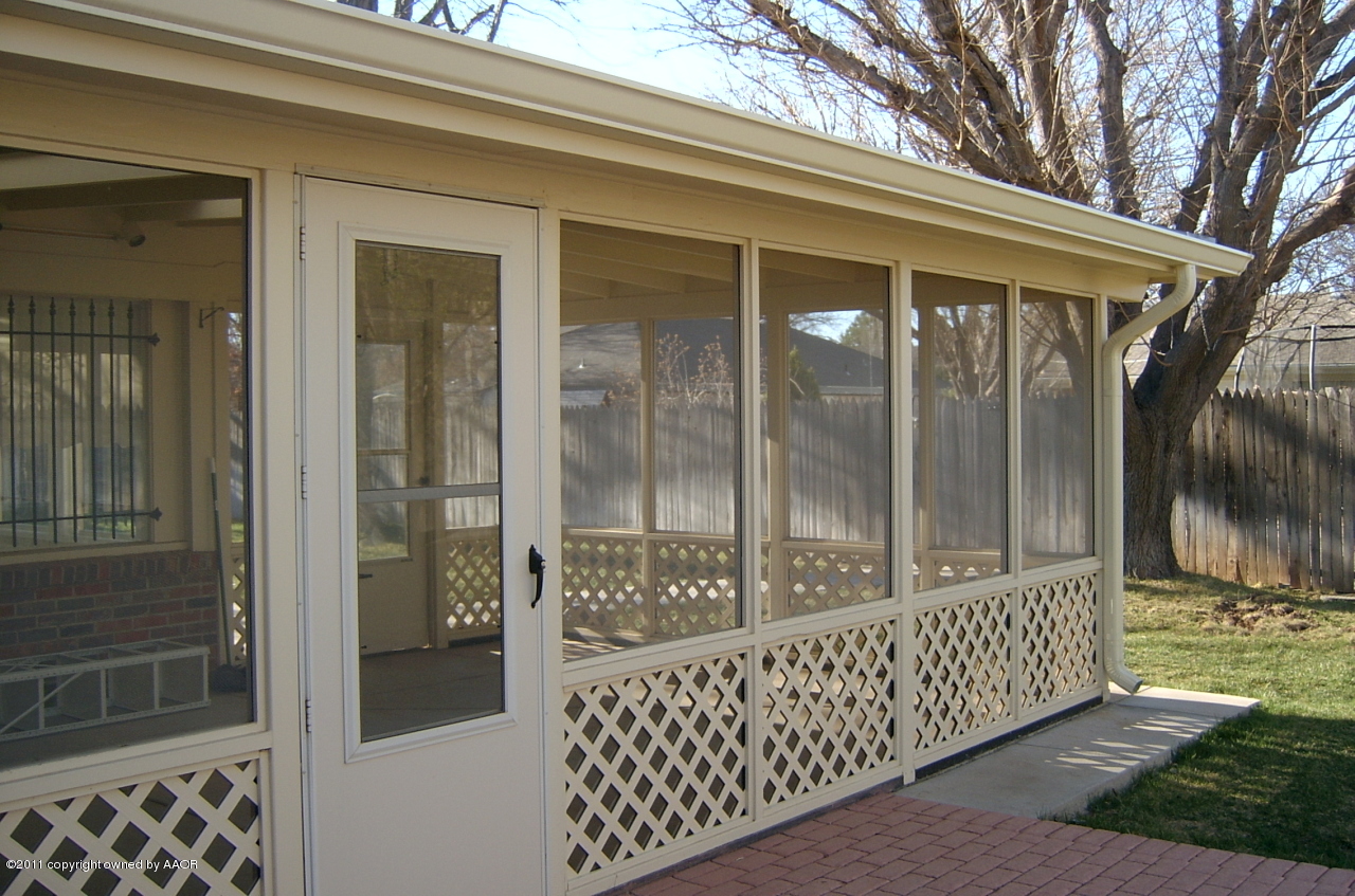 6903 Calumet Road Amarillo, TX 79106 - Photo 4 of 34 a view of a porch with a wooden fence and floor to ceiling window