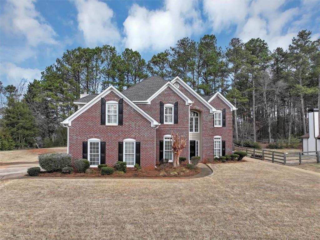 1440 Redbud Way Cumming, GA 30041 - Photo 1 of 1 a front view of a house with a yard and garage