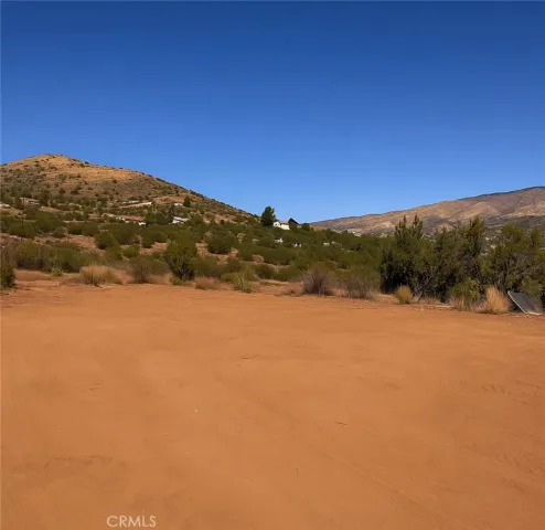 a view of mountain with sunset in background