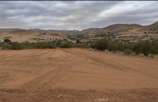 a view of an ocean beach and mountain