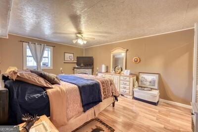 39 Shady Crk Ridge Marble, NC 28905 - Photo 12 of 64 a spacious bedroom with a bed a table and painting