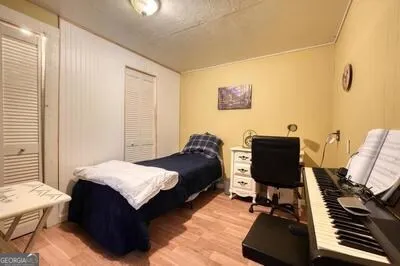 a bedroom with a bed and a chandelier