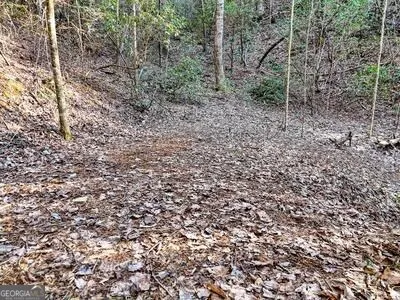 a view of a chair and table in backyard of the house