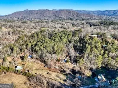 a spacious bedroom with a bed and a chandelier