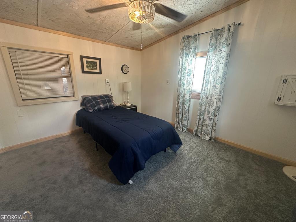 39 Shady Crk Ridge Marble, NC 28905 - Photo 59 of 64 a spacious bedroom with a bed and a chandelier