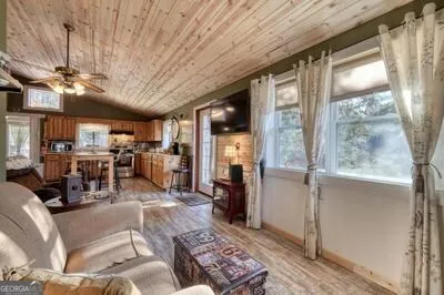 a kitchen with stainless steel appliances granite countertop a stove a sink dishwasher and cabinets with wooden floor