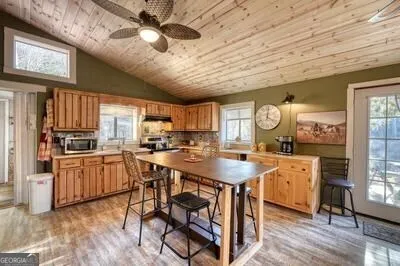 a kitchen with stainless steel appliances granite countertop a stove a sink dishwasher and a microwave oven with cabinets