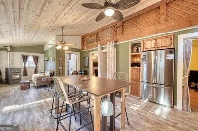 a spacious bedroom with a bed a table and painting