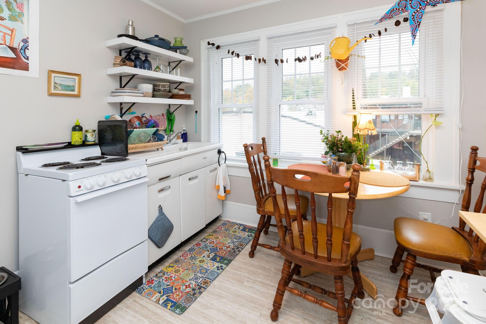 16 Gracelyn Road Asheville, NC 28804 - Photo 14 of 22 a view of a dining room with furniture window and wooden floor