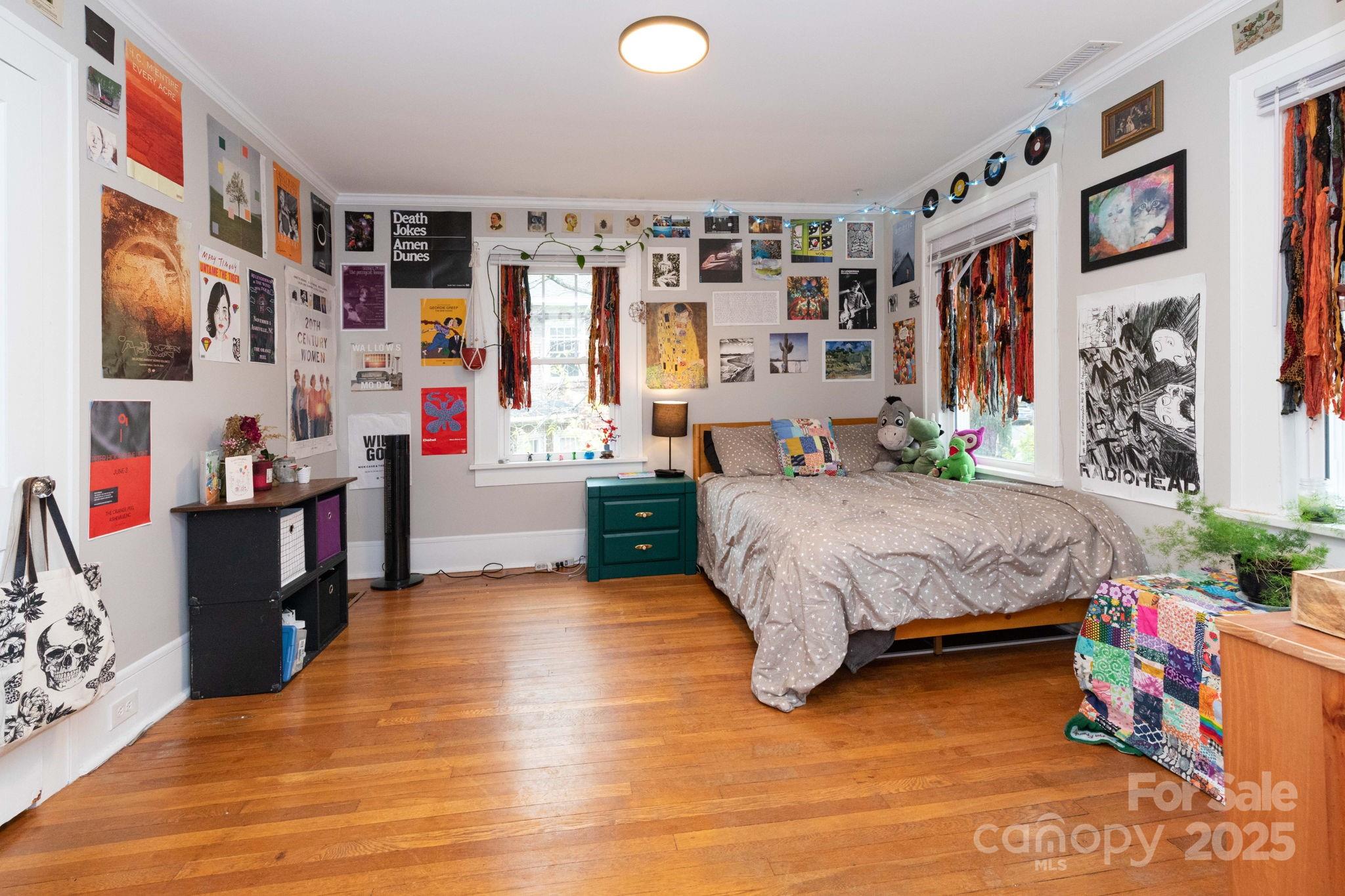 16 Gracelyn Road Asheville, NC 28804 - Photo 18 of 22 a spacious bedroom with a bed closet and a large window